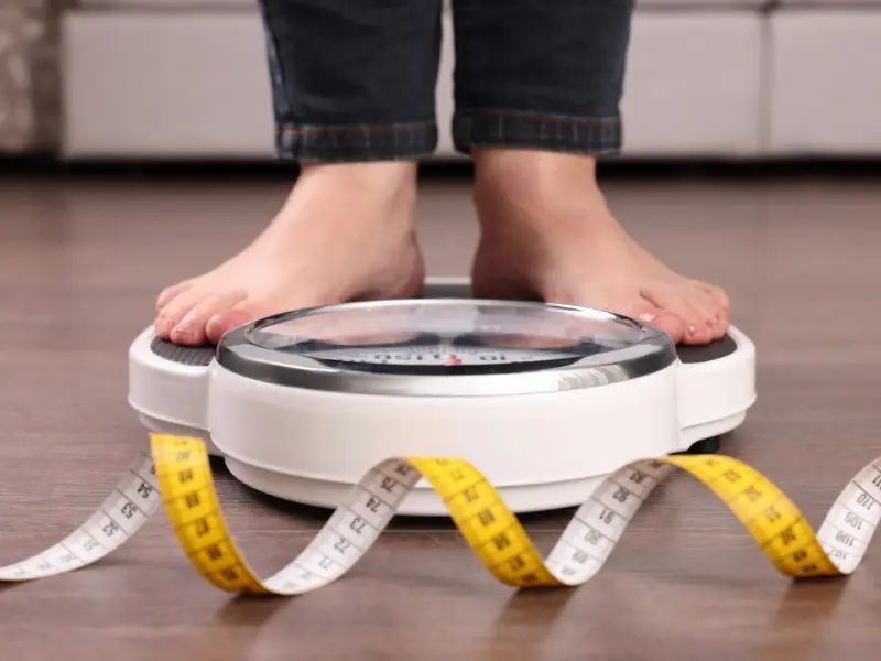 Woman standing on a scale.
