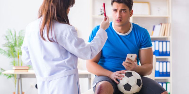 doctor performing a sports physical