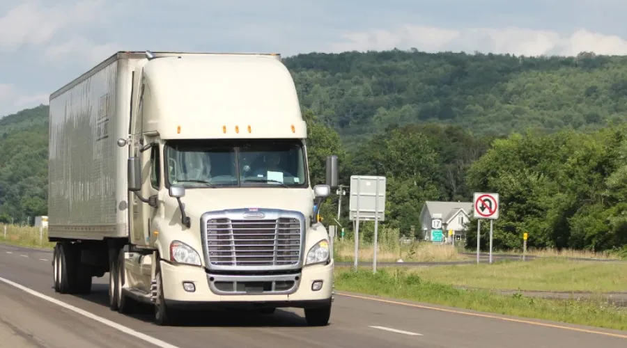 Commercial semi truck driving on the highway.
